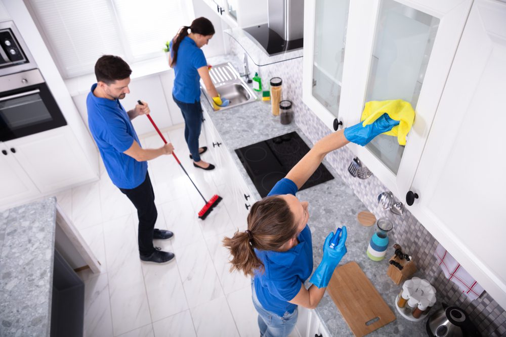 Group,Of,Young,Janitors,In,Uniform,Cleaning,Kitchen,At,Home house cleaning